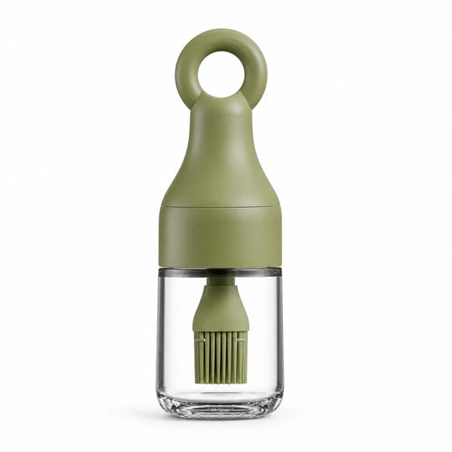 Olive green 3-in-1 oil dispenser bottle with silicone basting brush on a white background